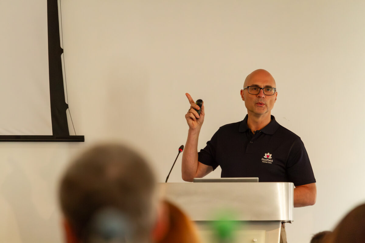 Alex Green presenting at the Radfield Home Care Conference 2025